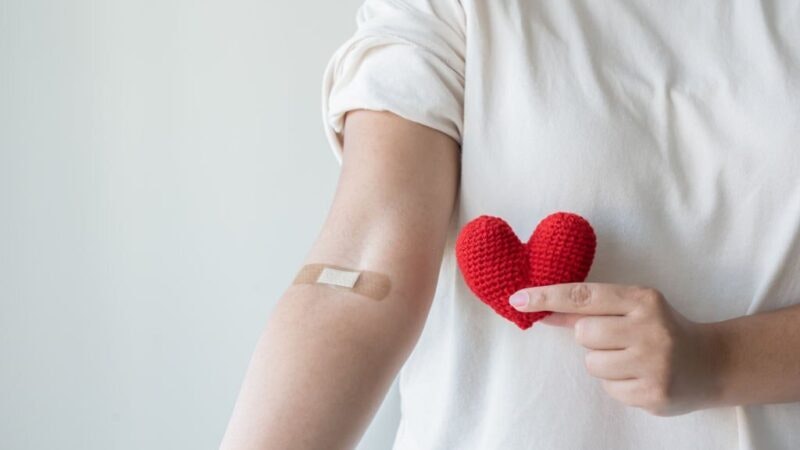 Blood donation concept. Give blood save up to three lives. Woman arm with the bandage plaster showing as a blood donation volunteer.